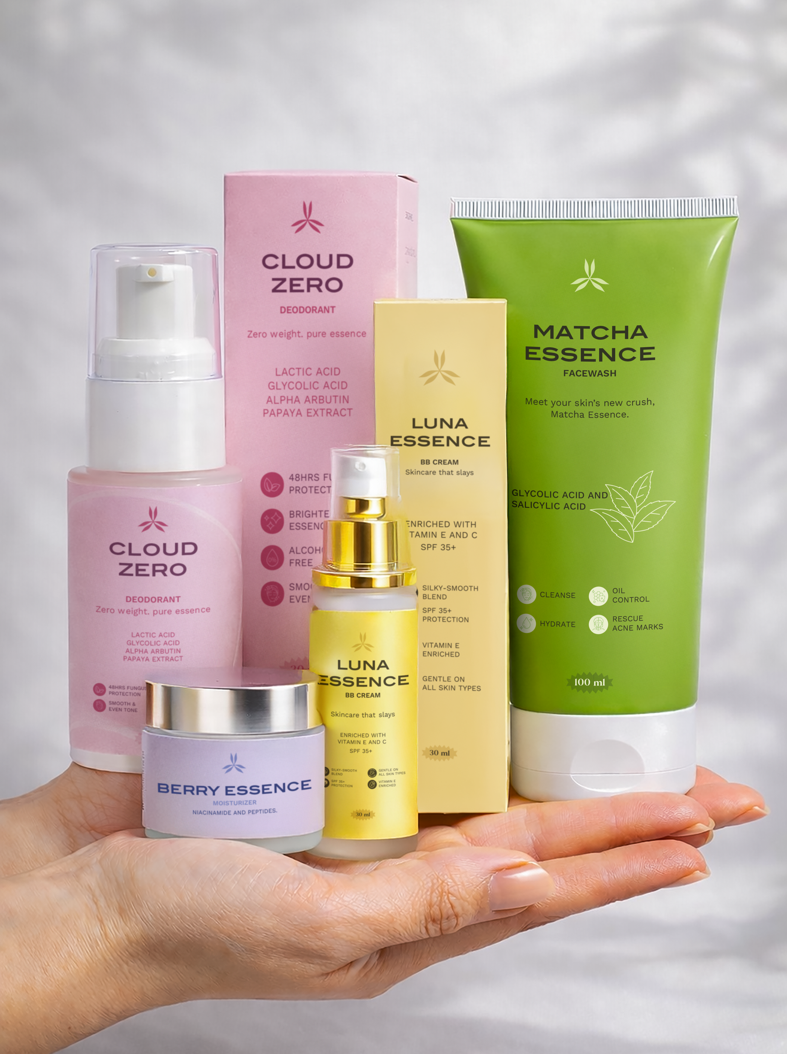 Collection of skincare products from Cloud Zero, Luna Essence, and Matcha Essence held in a hand against a neutral background.